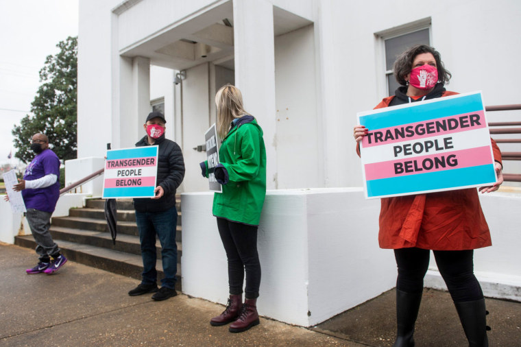 Protesters in support of transgender rights line up near the entrances of the Alabama State House in Montgomery on March 2, 2021.