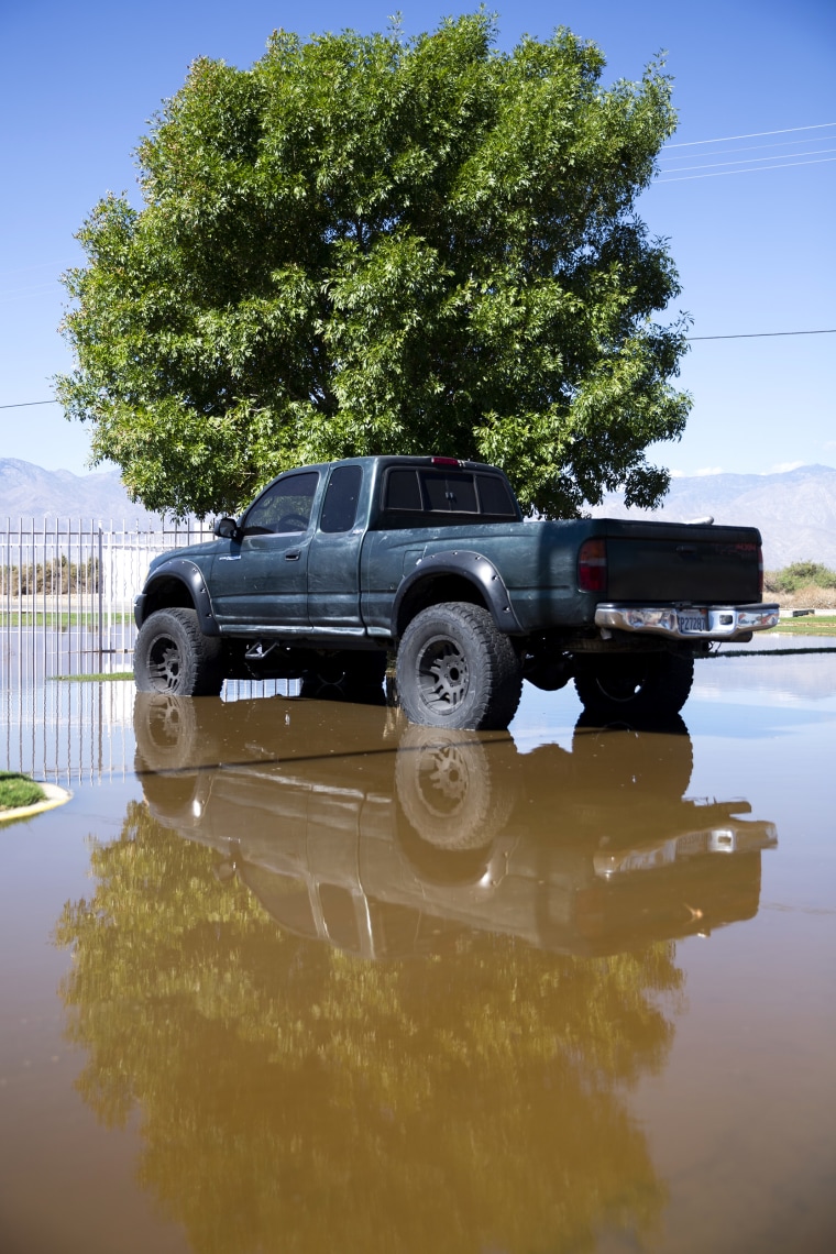 A car sits in a flooded parking lot from Hurricane Hillary at the preschool Mecca Migrant Head Start in Mecca, CA., on Tuesday, August 22, 2023.