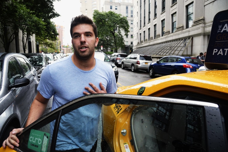 Billy McFarland enters a yellow taxi on a New York street
