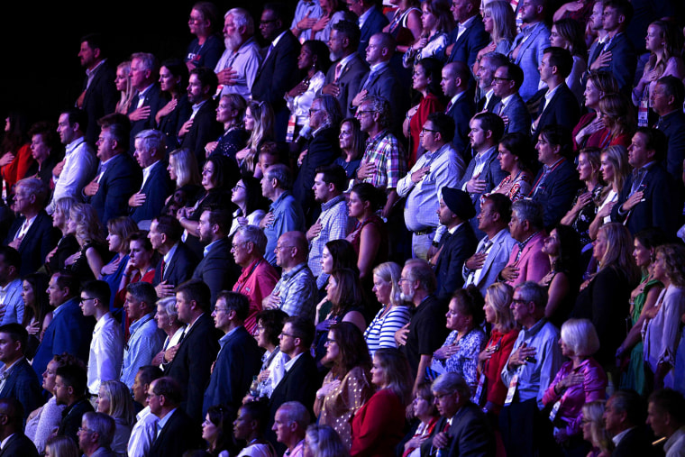 Image: Attendees stand for the national anthem at the Republican presidential primary debate in Milwaukee on Wednesday night.