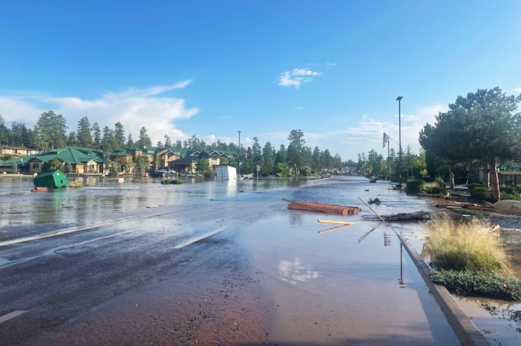Water and debris is flooded along Hwy. 64 in Tusayan, Ariz., on Tuesday.