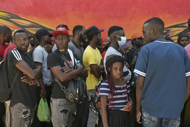 Haitian migrants line up at a migrant shelter in Tijuana, Mexico