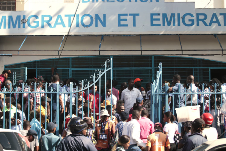 Haitians line up outside an immigration office