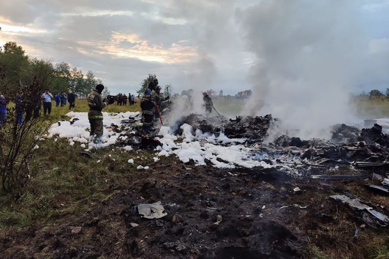 Worker at the site of a plane crash near the village of Kuzhenkino, Russia