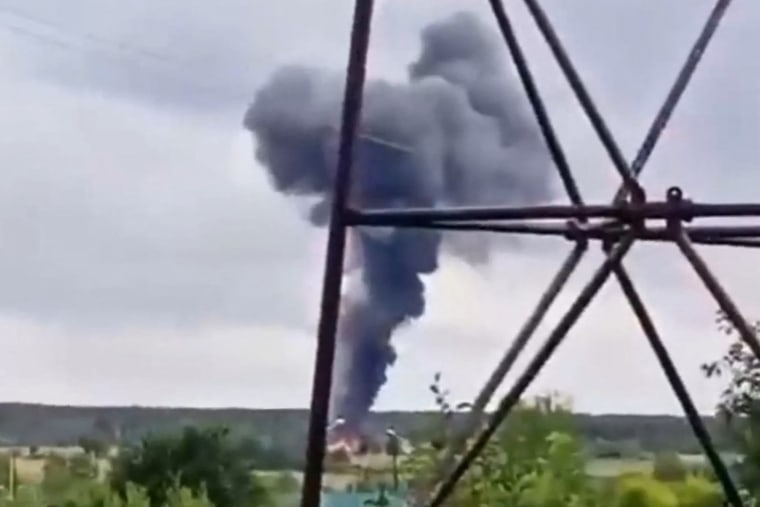 Smoke rises over a plane wreckage near the village of Kuzhenkino, Russia