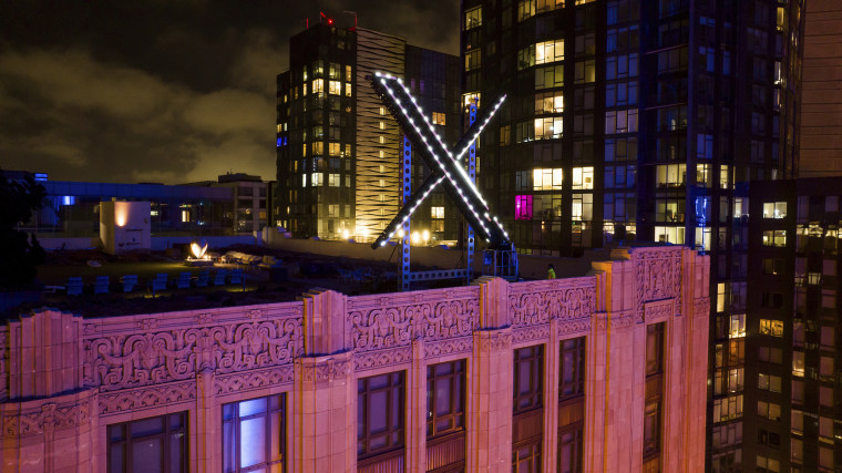 The X logo is illuminated atop its headquarters in San Francisco