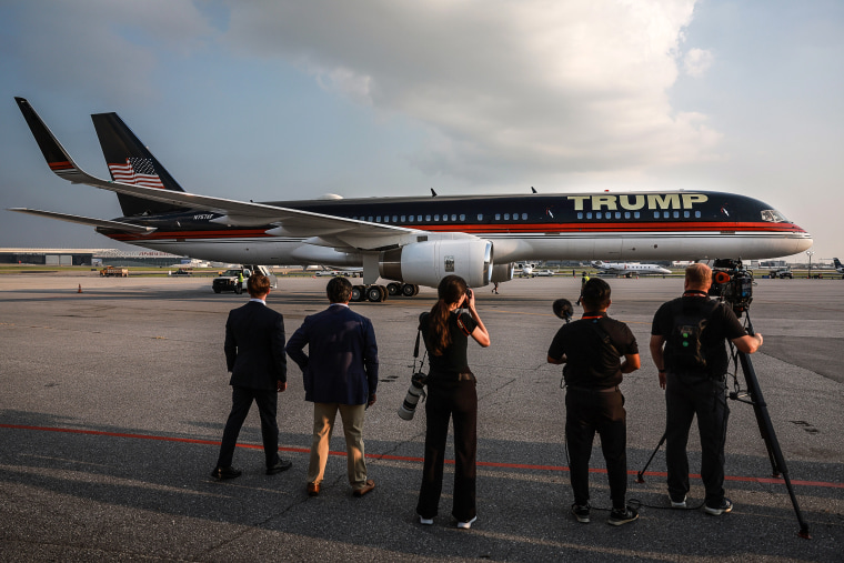 Image: Members of the media stand by as former President Donald Trump's private airplane, also known as Trump Force One, arrives at Atlanta Hartsfield-Jackson International Airport on Aug. 24, 2023 in Atlanta.