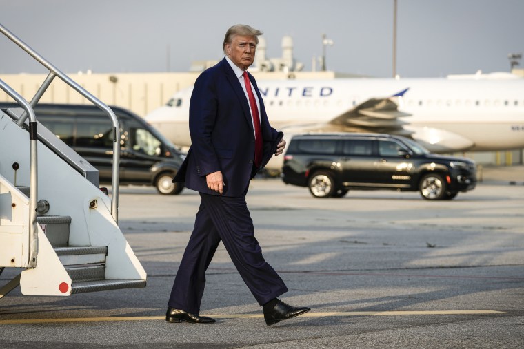 Former President Donald Trump steps off his plane as he arrives at Hartsfield-Jackson Atlanta International Airport on Aug. 24, 2023, in Atlanta.