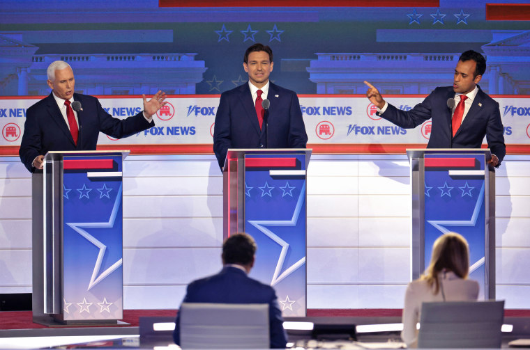 Republican presidential candidates, from left, former Vice President Mike Pence, Florida Gov. Ron DeSantis and Vivek Ramaswamy participate in the first debate of the GOP primary season on Aug. 23, 2023 in Milwaukee.