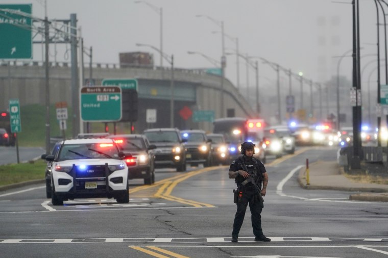 Image: A police officer Former President Donald Trump's motorcade travels to Newark Liberty International Airport in New Jersey on Thursday.