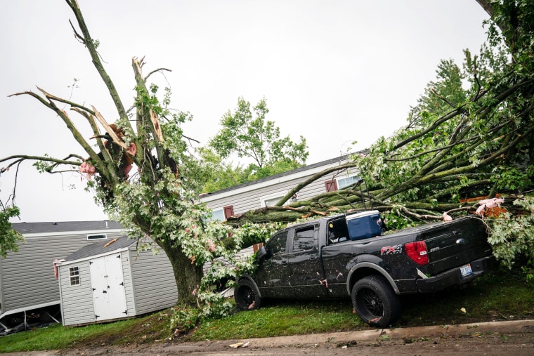 A truck sits with a tree toppled on it in the Frenchtown Villas Monroe in Newport on Friday, Aug. 25, 2023 after a heavy band of storms hit the region on Thursday, Aug. 24, 2023.