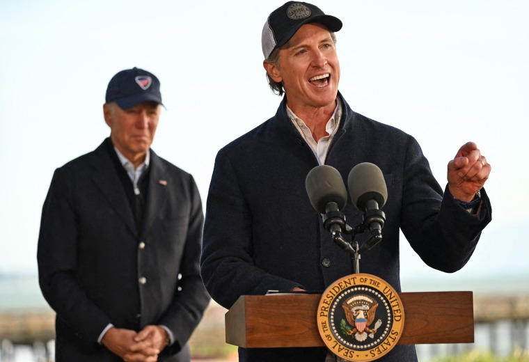 President Joe Biden listens to California Gov. Gavin Newsom deliver remarks after looking at storm damage in Seacliff, Calif., on Jan. 19, 2023. 