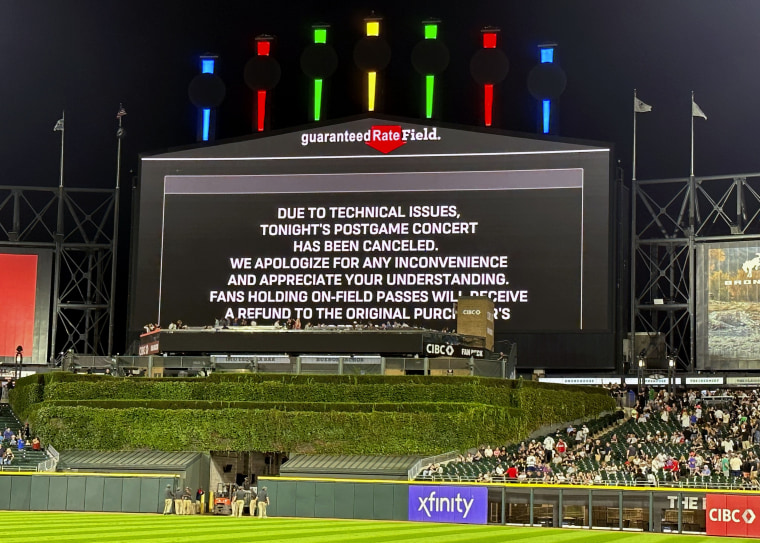 A message on the main scoreboard at Guaranteed Rate Field announces the cancellation of a '90s concert that was to feature Vanilla Ice, Tone Loc and Rob Base after a baseball game between the Chicago White Sox and the Oakland Athletics, Friday, Aug. 25, 2023, in Chicago.