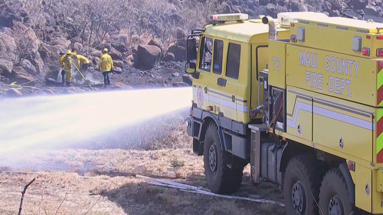 Fire crews work to stop the advancement of a brush fire that broke out Saturday, Aug. 26, 2023, in a neighborhood of Lahaina, Hawaii. 