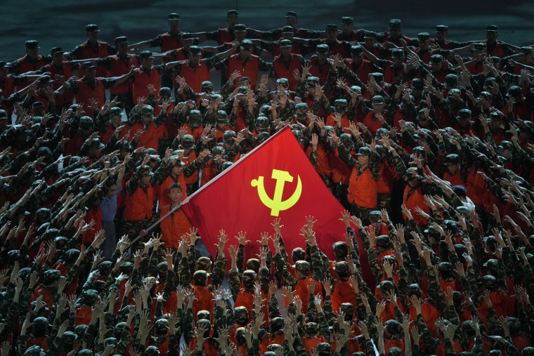 Performers gather around a Communist Party flag during a gala show ahead of the 100th anniversary of the founding of the Chinese Communist Party in Beijing on  June 28, 2021. 