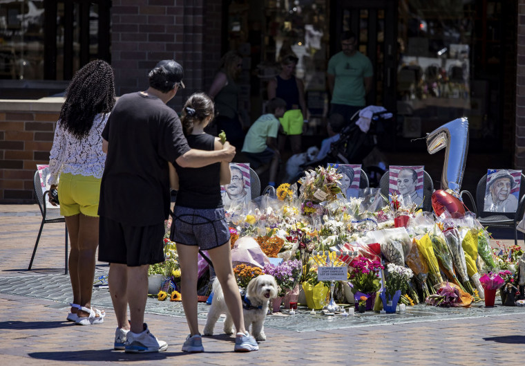 People visit a memorial six days after a mass shooting during the Fourth of July parade in Highland Park, Illinois for seven of the victims in Port Clinton Square on July 10, 2022.