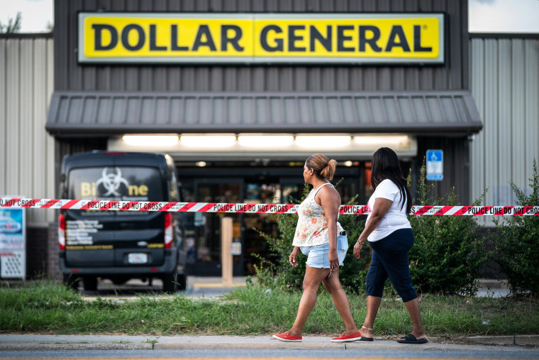 Image: People walk past the Dollar General store where three people were shot and killed the day before on Aug. 27, 2023 in Jacksonville, Fla.