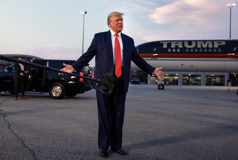 Former U.S. President Donald Trump speaks to the media at Atlanta Hartsfield-Jackson International Airport after surrendering at the Fulton County jail  in Atlanta on Aug. 24, 2023. 