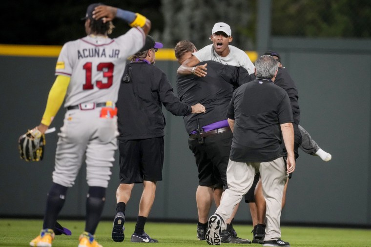 Atlanta Braves outfielder Ronald Acuña Jr. confronted by two fans who  stormed field midgame