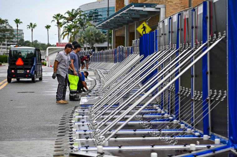 Workers set up a fence to prevent flooding at Tampa General Hospital in Tampa, Fla., on Aug. 29, 2023 as the city prepares for Hurricane Idalia. 