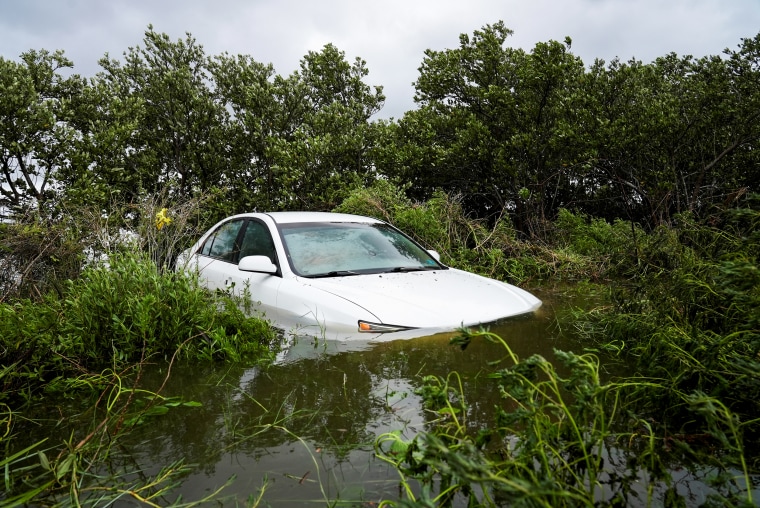 A vehicle is partially submerged after the arrival of Hurricane Idalia, in Cedar Key, Fla., on Aug. 30, 2023.
