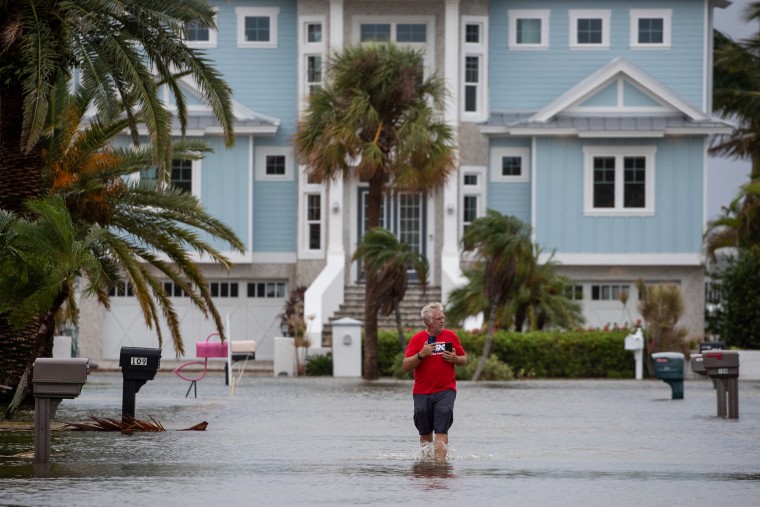 Mike Sellers surveys flood waters after wading in to check on his mother in the aftermath of Hurricane Idalia in Clearwater Beach, Fla., on Aug. 30, 2023.