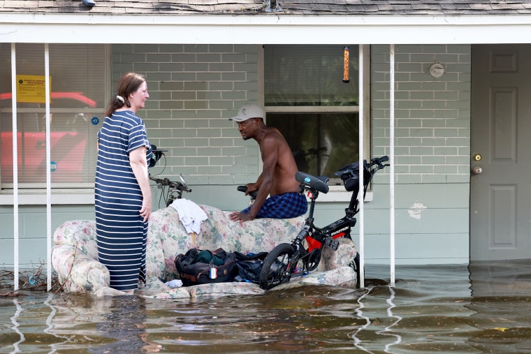 Residents outside of flooded apartment after Hurricane Idalia passed offshore on Aug. 30, 2023 in Crystal River, Fla.