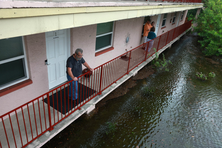 Ken Kruse looks out at the flood waters from Hurricane Idalia surrounding his apartment complex in Tarpon Springs, Fla.