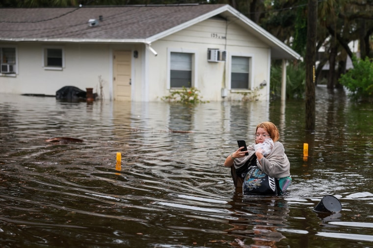 Makatla Ritchter evacuates her home during Hurricane Idalia in Tarpon Springs, Fla., on Aug. 30, 2023.