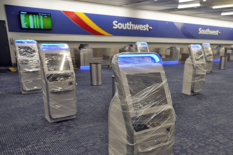 Kiosks at the Southwest Airlines ticket counter are covered in protective wrapping at the Tampa International Airport on Aug. 29, 2023.