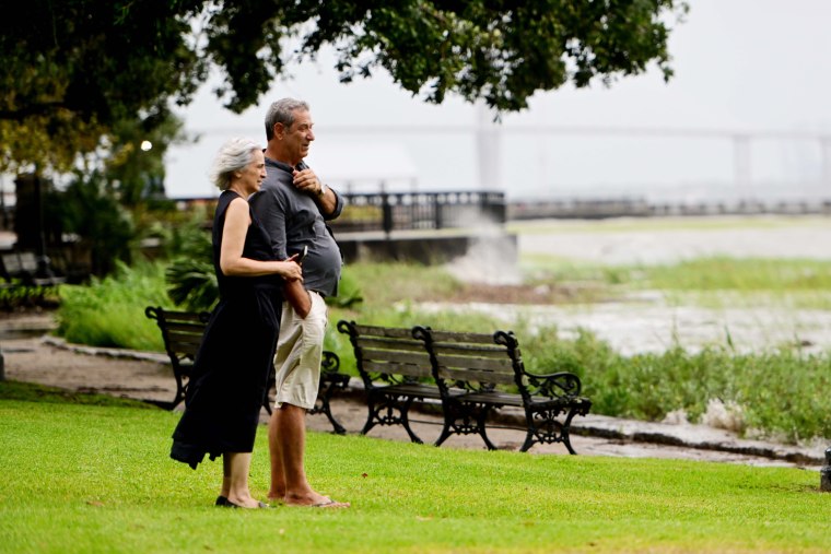 Donatella and Giulio Della Porto watch on as waves hit Waterfront Park in Charleston, S.C. on Aug. 30, 2023.