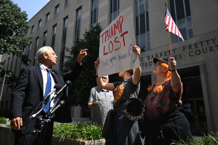 Peter Navarro gestures at demonstrators outside the courthouse in Washington on Aug. 30, 2023, following a pre-trial hearing.
