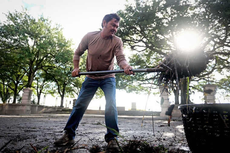 Alex Garcia, 55, shovels debris from Tropical Storm Idalia in Charleston, S.C. on Aug. 31, 2023.