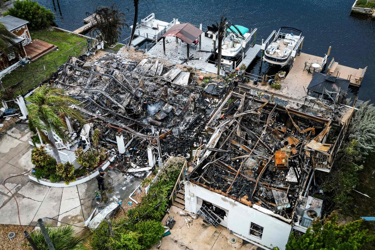 Image: Burned rubble where a house stood after a power transformer explosion in the community of Signal Cove in Hudson, Fla., on Aug. 30, 2023, after Hurricane Idalia made landfall.