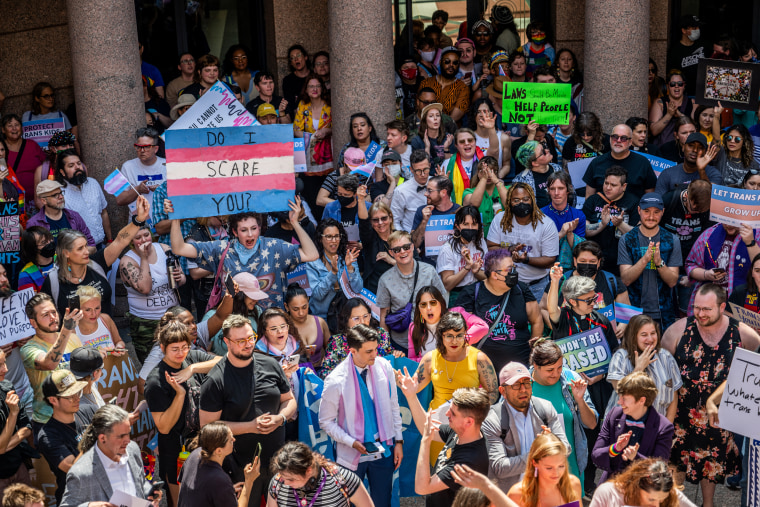 People protest bills that would limit healthcare for transgender youth in Austin on March 27, 2023.