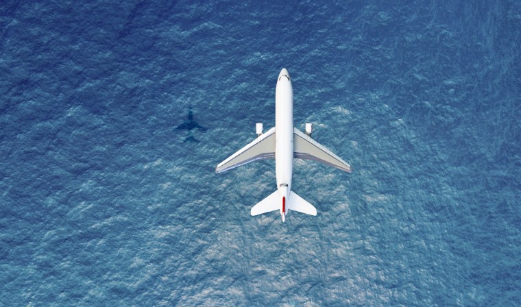 Airplane flies over a sea