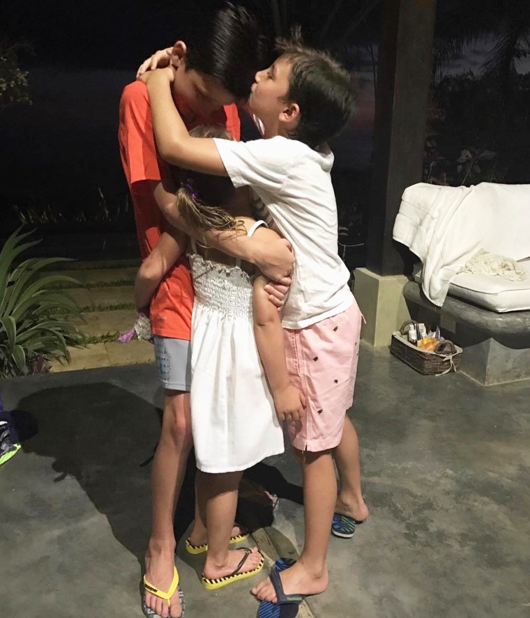 Tom Brady's three kids, Jack, Benjamin and Vivian stand in a group hug.