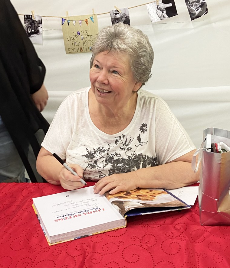 Linda Skeens signs her cookbook at the VaKy District Fair.
