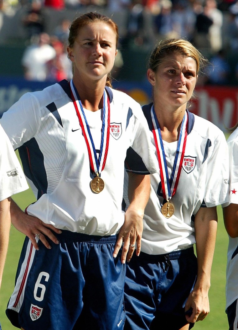 Mia Hamm and Brandi Chastain wearing medals at the FIFA 2003 Women's World Cup third-place match.