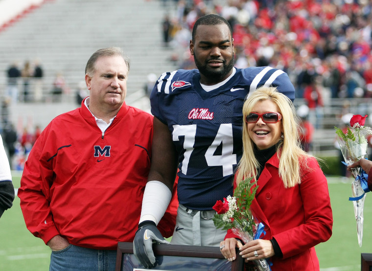 Michael Oher #74 of the Ole Miss Rebels stands with his family 