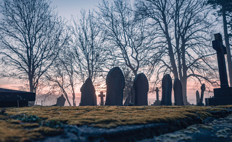 Headstones in a misty graveyard.