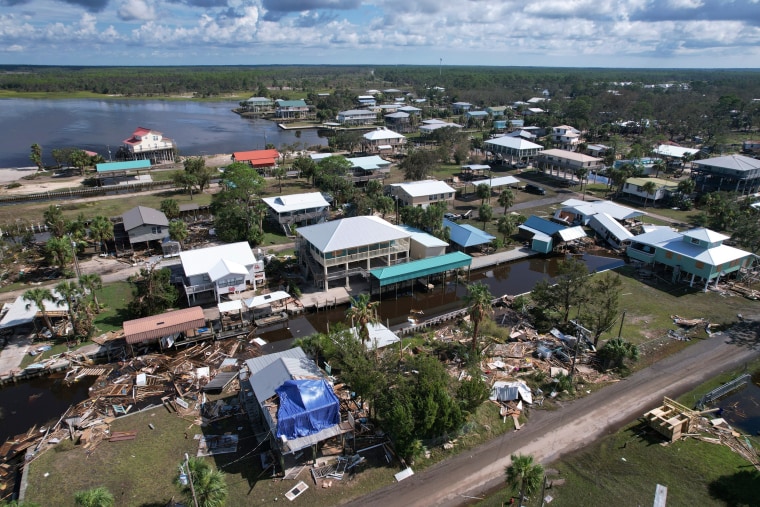 Debris from homes swept off their lots is scattered amid homes on stilts which survived, in Horseshoe Beach, Fla., on Aug. 31, 2023, one day after the passage of Hurricane Idalia.