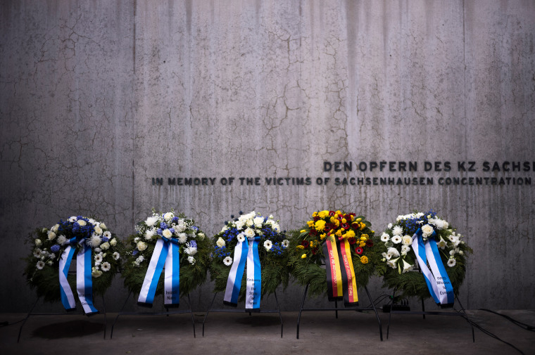  Wreaths at the memorial wall of the Nazi concentration camp Sachsenhausen after a ceremony marking the Holocaust Martyrs' and Heroes' Remembrance Day in Oranienburg, Germany, on April 18, 2023. 