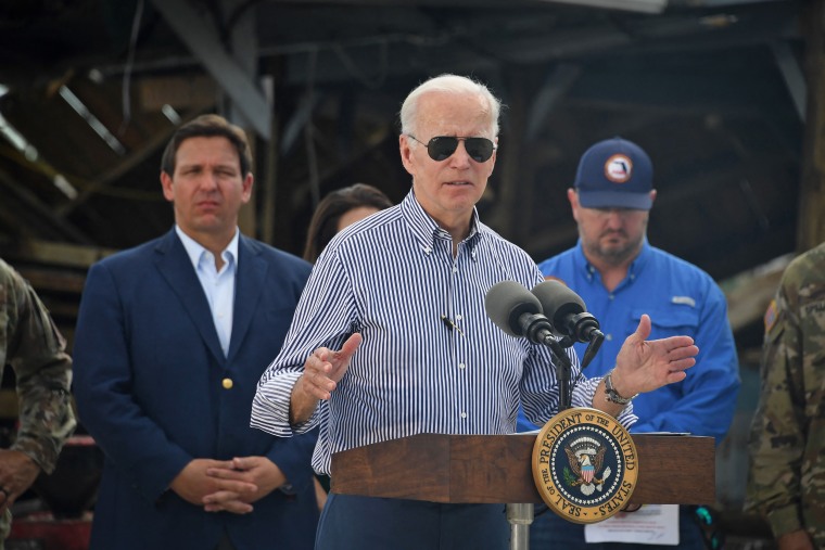 President Joe Biden speaks in a neighborhood impacted by Hurricane Ian in Fort Myers, Fla., on Oct. 5, 2022 as Florida Governor Ron DeSantis looks on. 