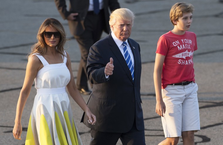 Melania Trump, then-President Donald Trump and their son Barron walk to board Air Force One