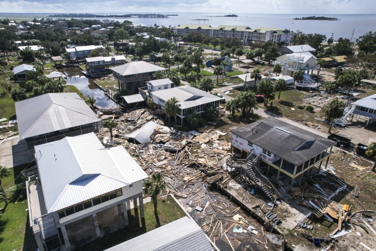 Image: Debris from homes swept off their lots chokes a canal amid homes on stilts which remain standing, in Horseshoe Beach, Fla., on Aug. 31, 2023, one day after the passage of Hurricane Idalia.