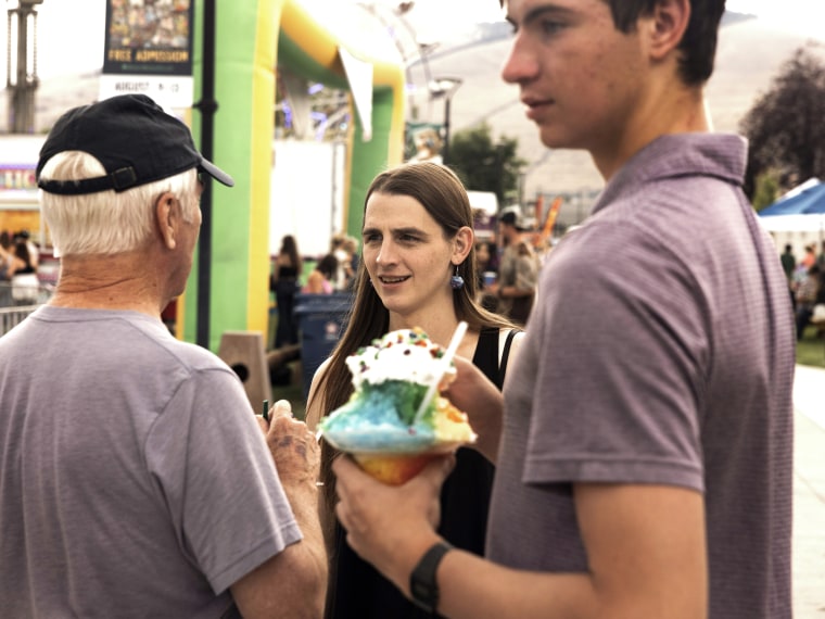 Rep. Zooey Zephyr chats with constituents at the Western Montana Fair in Missoula, Mont., on Aug. 9, 2023.