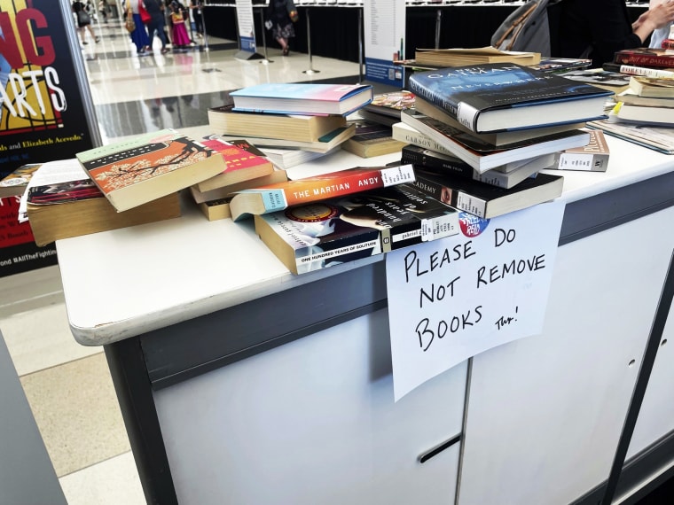 Banned books are stacked at an exhibit at the American Library Association's conference