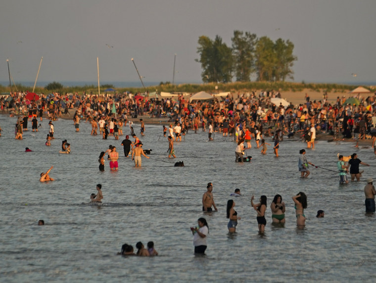Beachgoers crowd Montrose Beach in the early evening Monday, Sept. 4, 2023, in Chicago. 