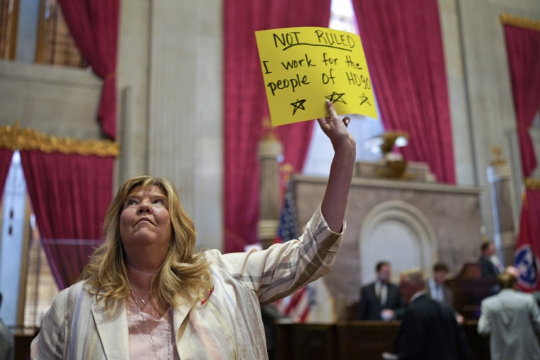 Rep. Gloria Johnson, D-Knoxville, holds a sign on the House floor after a special session of the state legislature on public safety adjourned on Aug. 29, 2023, in Nashville.